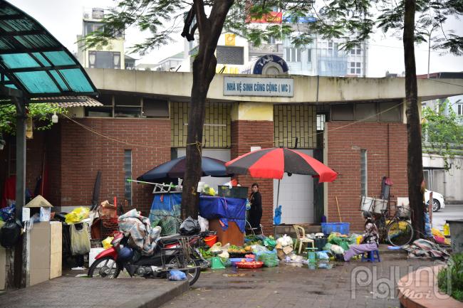 Bày bán rau củ quả tại cửa nhà vệ sinh công cộng Ngã Tư Sở.