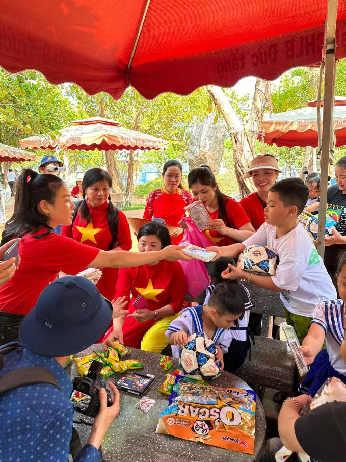 Các thành viên đoàn Trường Đại học Sư phạm Nghệ thuật Trung ương trao quà cho các em học sinh trên đảo Trường Sa