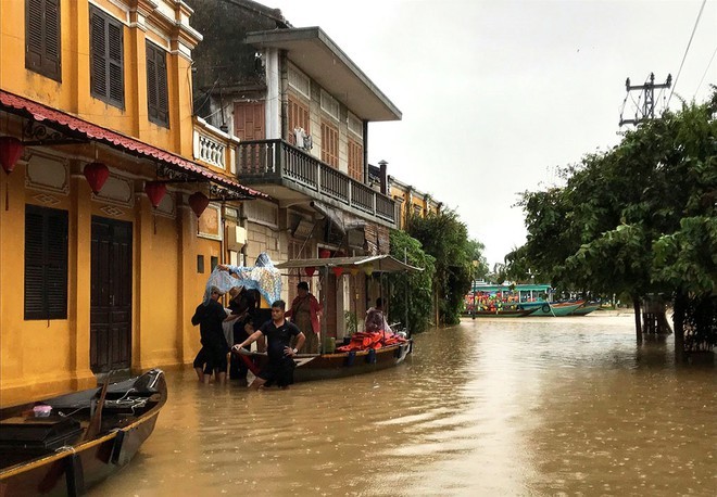 Hội An nước ngập khiến người dân phải dùng thuyền để đi lại. 