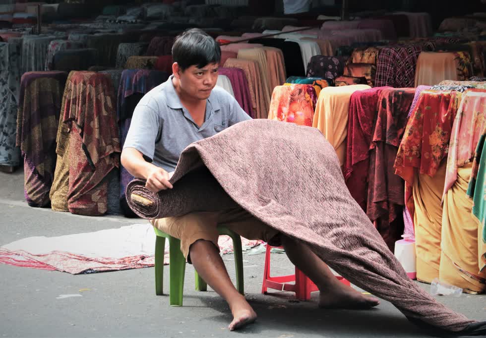 Thông thường, những trục đường xoay quanh chợ rất đông đúc và tấp nập người qua lại. Gần đây, số ca mắc COVID-19 ghi nhận tại TP.HCM nhiều nên người dân cũng hạn chế đi lại, đường ít xe, khu chợ cũng vắng khách. Một tiểu thương tại khu chợ hài hước nói: