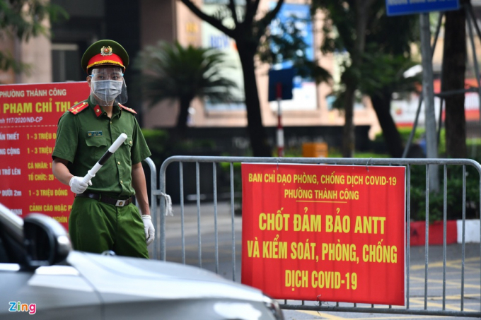           Thượng uý Lê Anh Dũng làm nhiệm vụ rà soát giấy người đi đường tại một chốt trên phố Giảng Võ. Tuy nhiên, để tránh tình trạng bị ùn ứ ở đầu chốt vào sáng thứ hai đầu tuần, nhiều chốt chặn phải nhanh chóng để cho xe đi qua.          