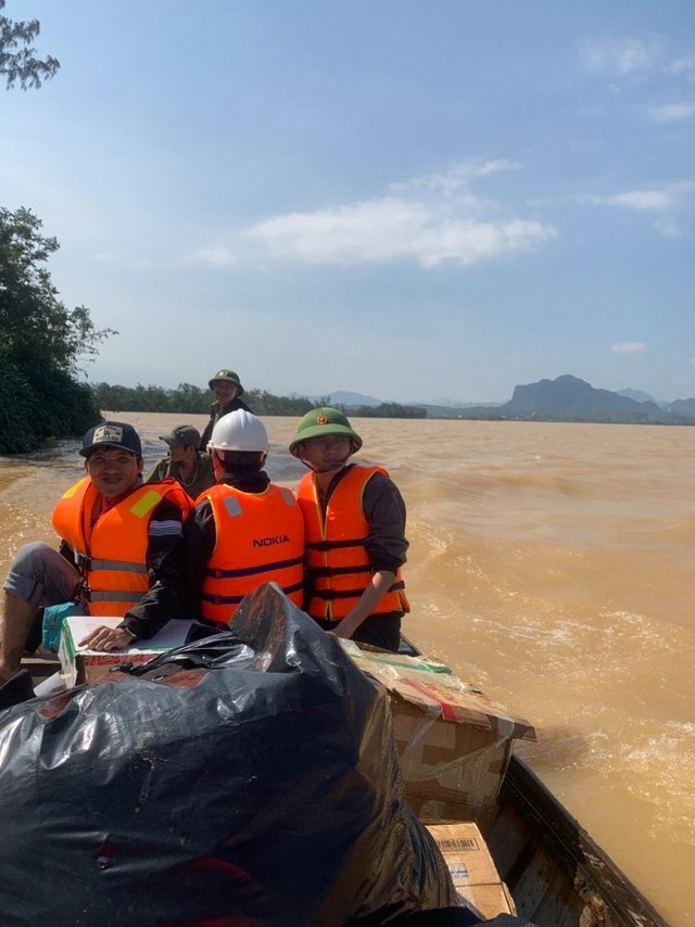 Dù lũ lụt nguy hiểm nhưng thầy Quý cùng các giáo viên trong trường vẫn đi cứu giúp bà trong hoạn nạn. Ảnh: FBNV