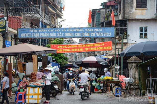 Cổng chính lối vào chợ tại khu dân cư số 10 phường Tân Mai tập trung đông dân cư đi lại. Việc kẻ vạch, phân luồng tại chợ là một sáng kiến hay giúp hướng dẫn người dân đảm bảo giãn cách khi mua bán.